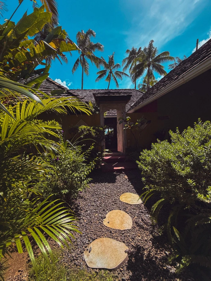 Entrance of the villa Hotu surronded by tropical vegetation