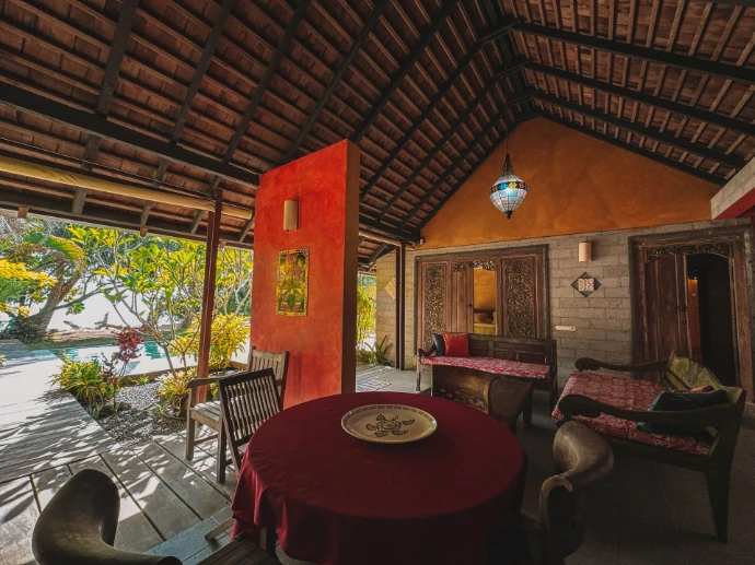 Open-plan living and dining area inside Villa Tamanu, Balinese design