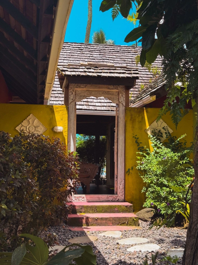 Entrance of Villa Tamanu surrounded by tropical vegetation