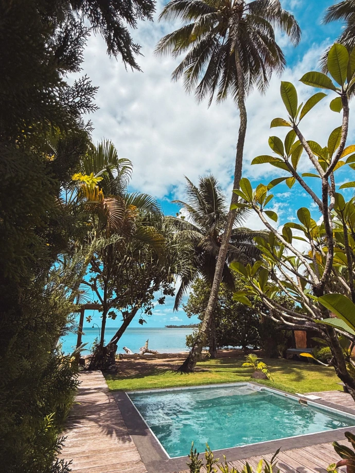 Villa Tamanu exterior with private pool and tropical garden with a lagoon view at Villa Mitirapa, Tahiti